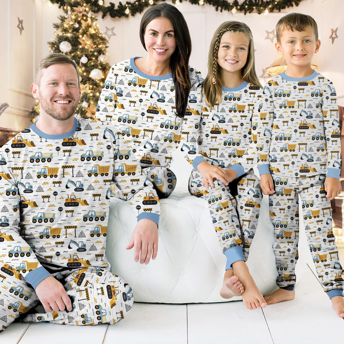 Another lifestyle view of family in matching pajamas with construction design
