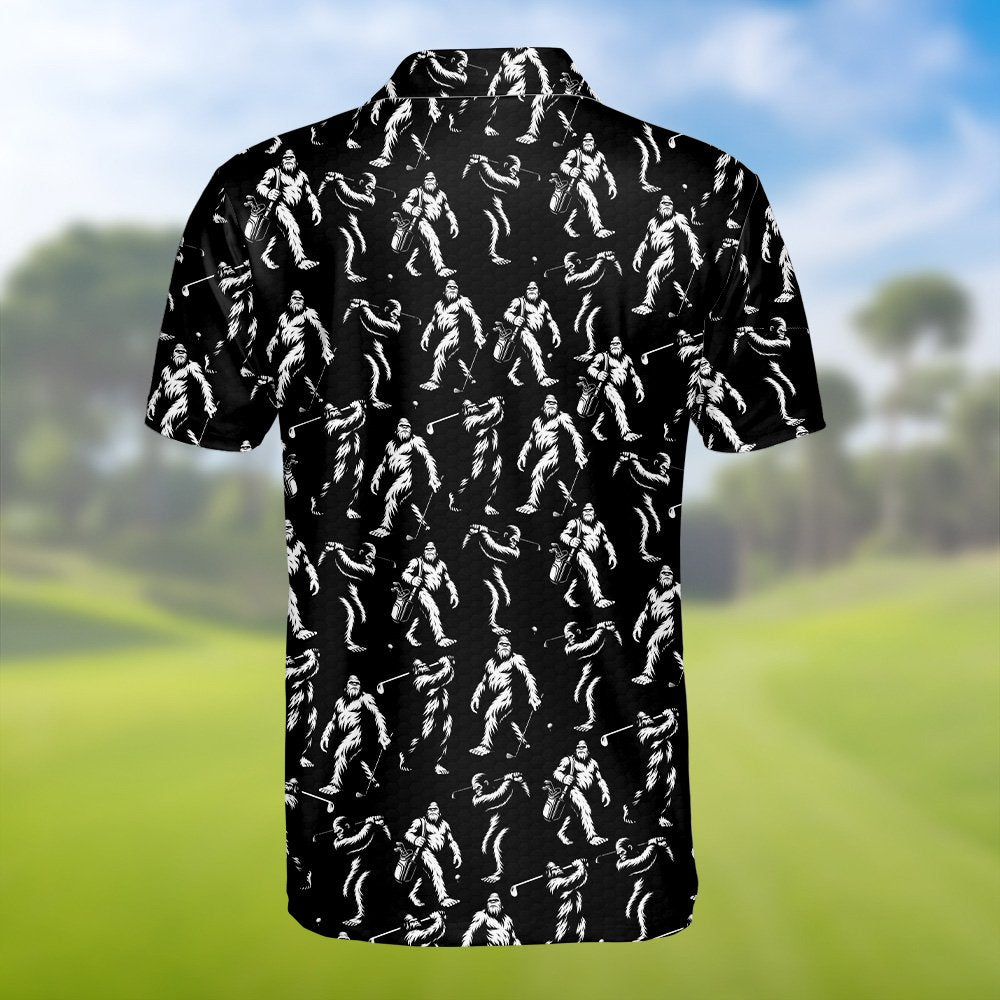 Black bigfoot polo shirt featuring white bigfoot figures golfing, flat lay back view