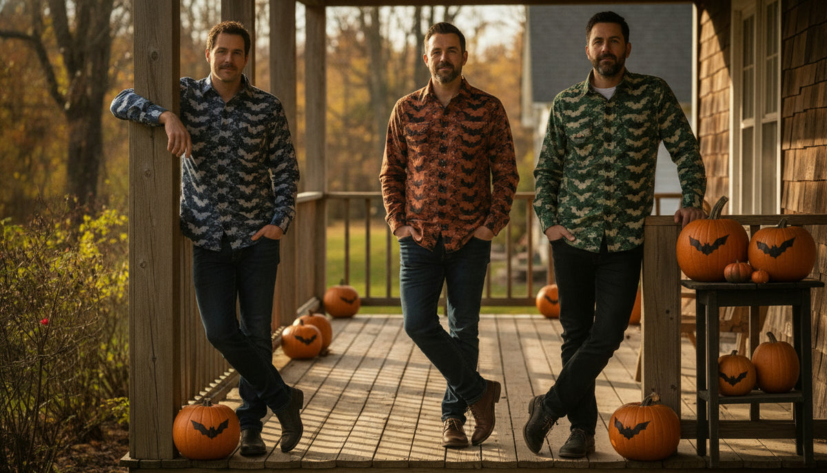 Three men wearing patterned casual shirts standing on a wooden porch with carved pumpkins in autumn daylight.