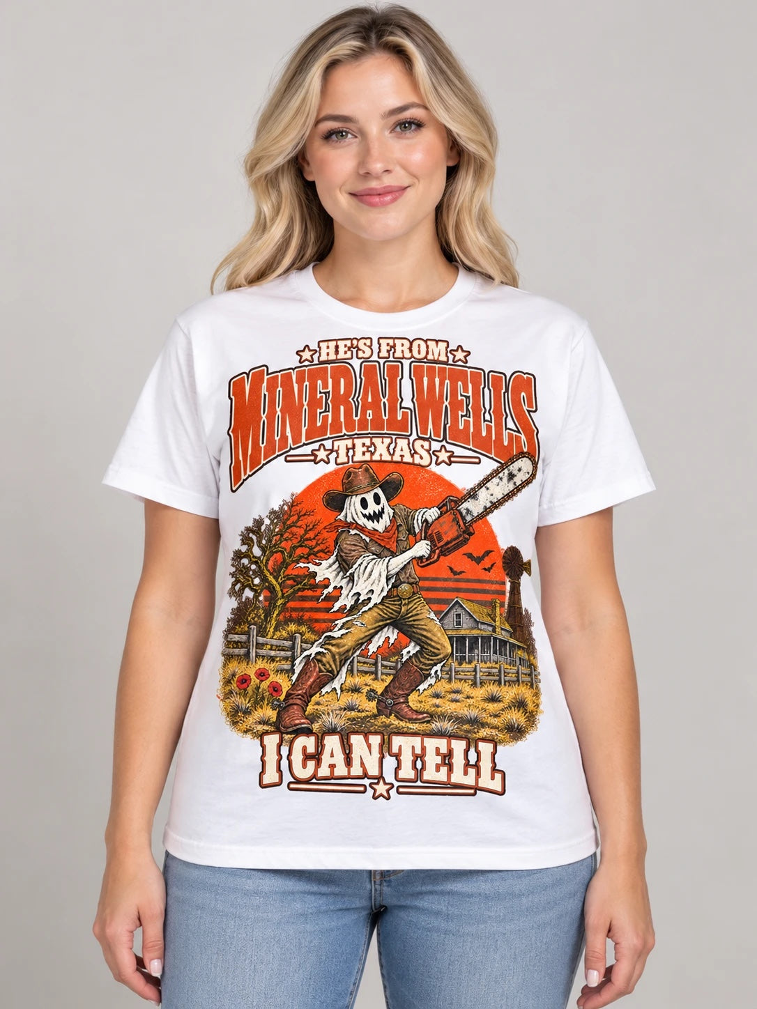 He's From Mineral Wells Texas I Can Tell Halloween t-shirt, ghost cowboy with chainsaw design on a white Comfort Colors 1717 tee