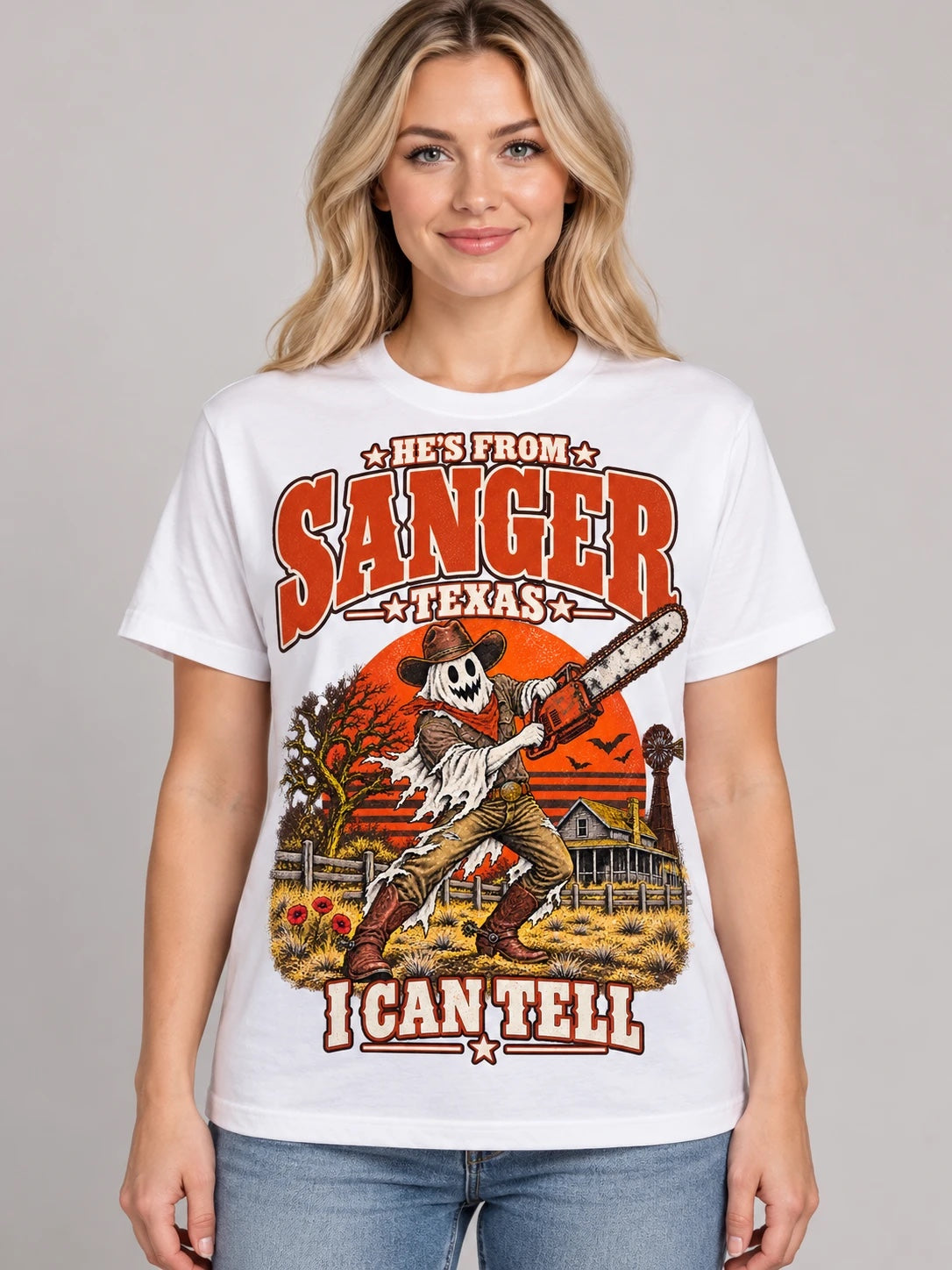 He's From Sanger Texas I Can Tell Halloween t-shirt, ghost cowboy with chainsaw design on a white Comfort Colors 1717 tee