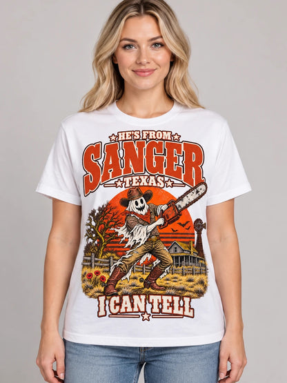 He's From Sanger Texas I Can Tell Halloween t-shirt, ghost cowboy with chainsaw design on a white Comfort Colors 1717 tee