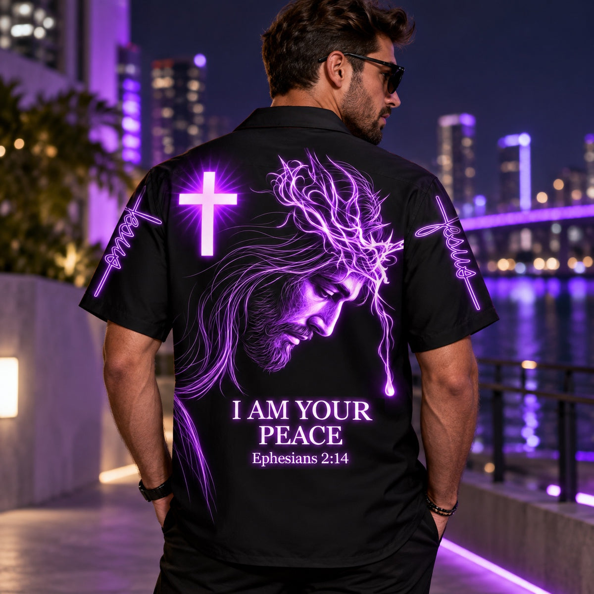 Man wearing the I Am Your Peace Christian Hawaiian shirt on a city waterfront at night