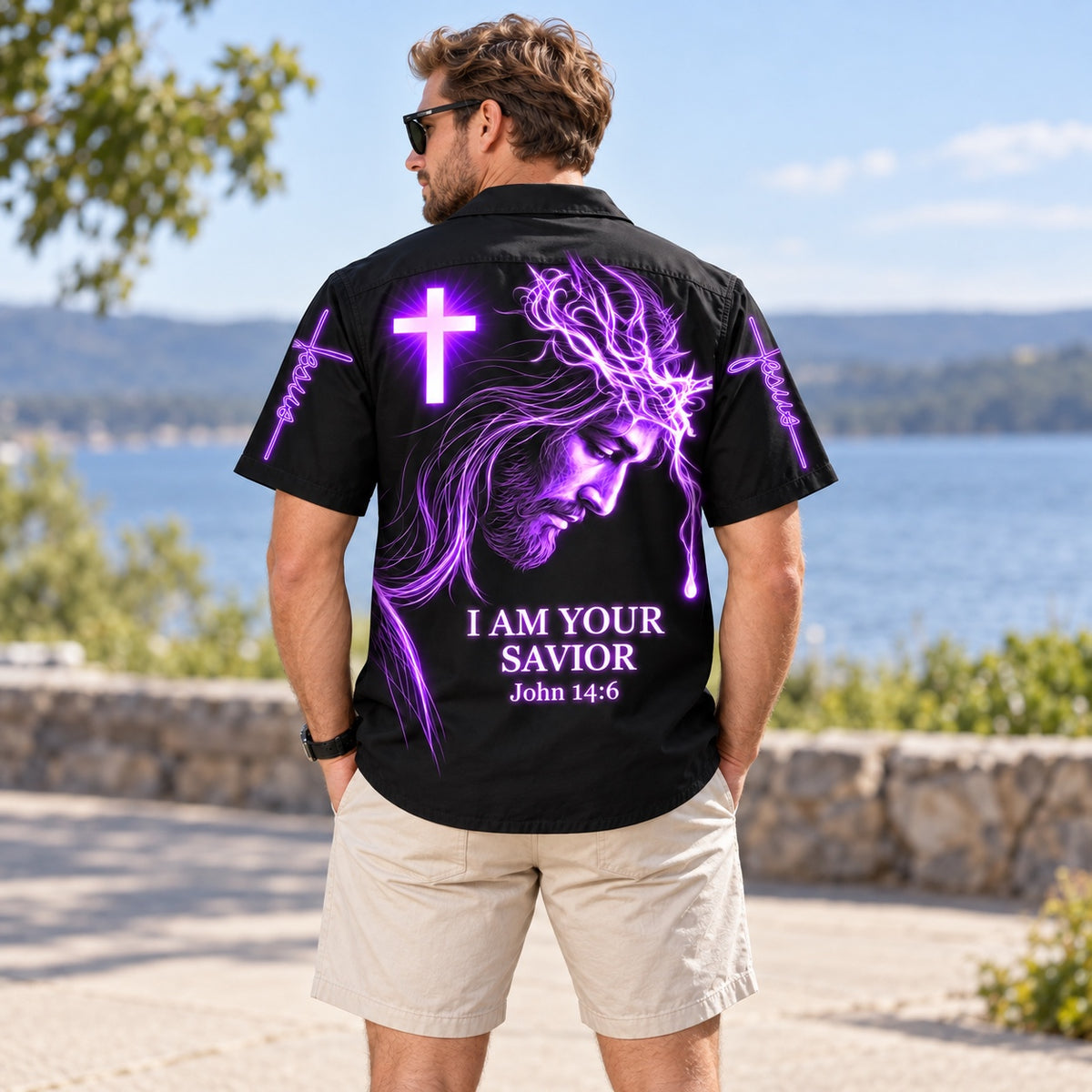 Man in the I Am Your Savior purple neon Jesus Hawaiian shirt by a lake, back view