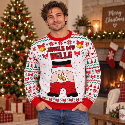 Man wearing the Jingle My Bells cheeky Santa ugly Christmas sweater by a Christmas tree and fireplace