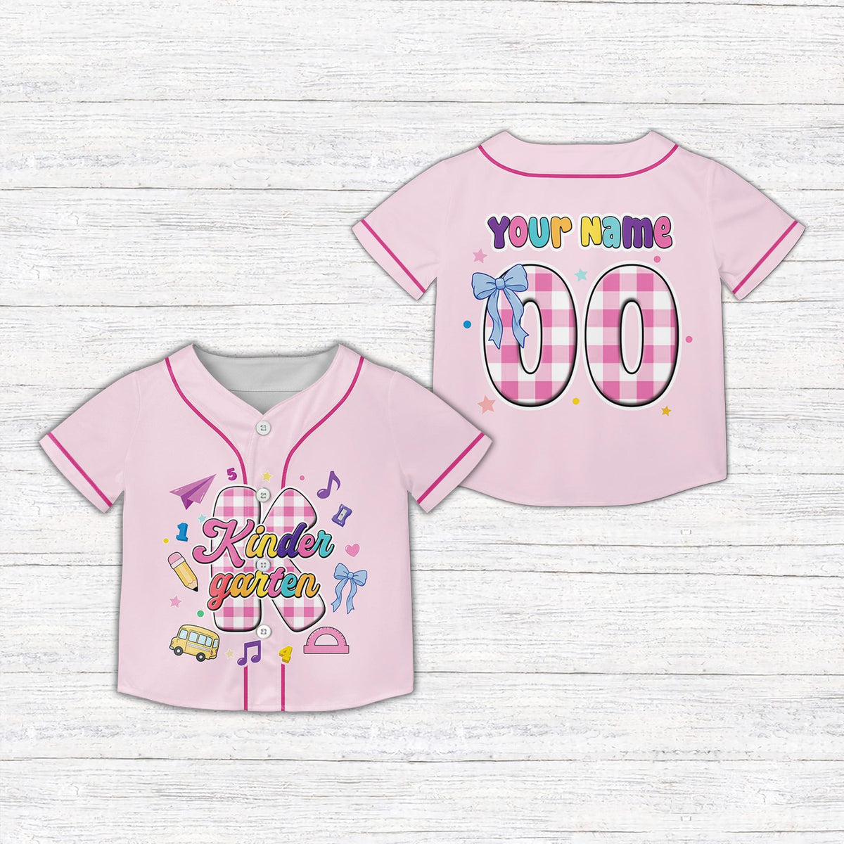 Pink kids jersey displaying educational graphics and plaid patterns, front view