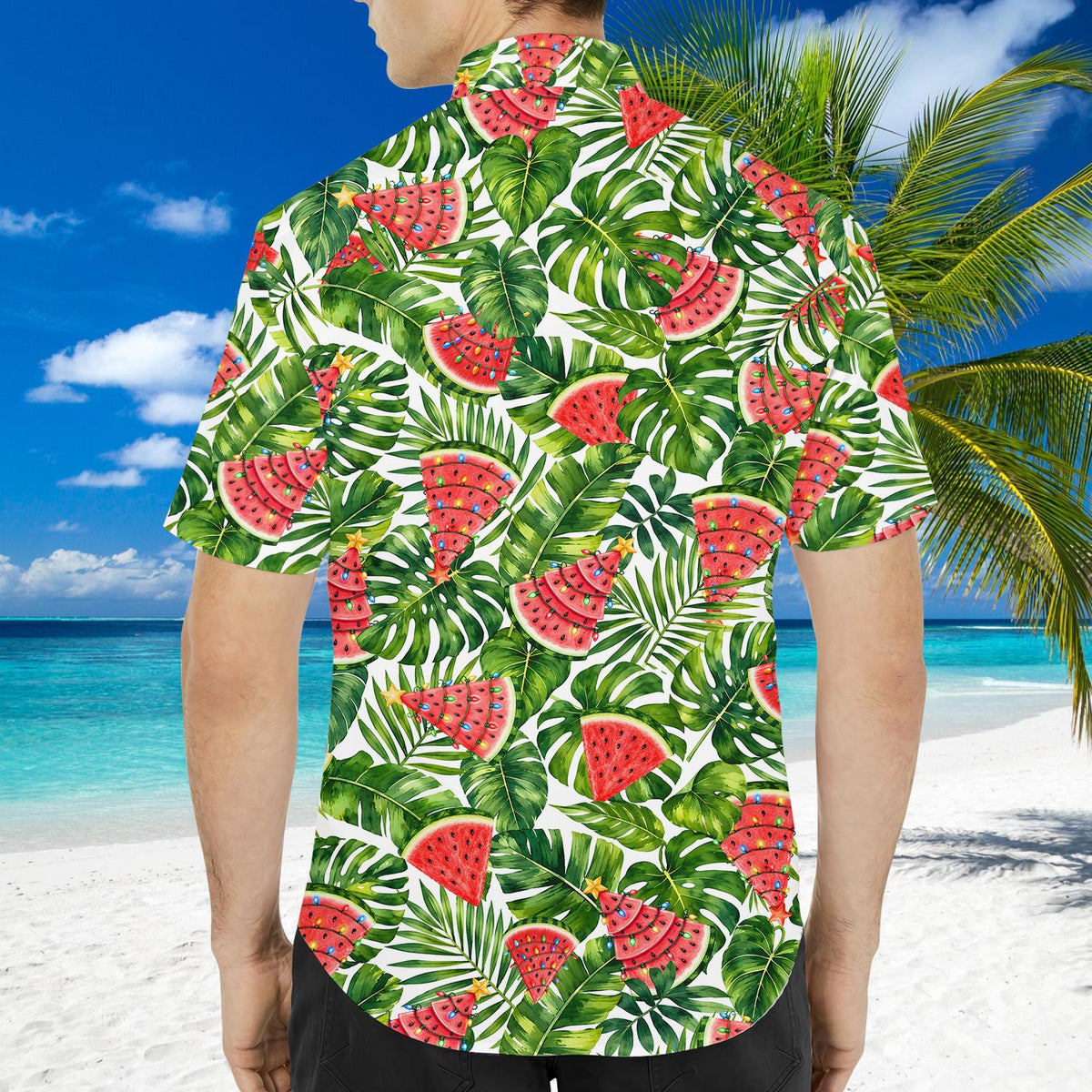 Close-up lifestyle view of the tropical palm and monstera leaf pattern on the matching family shirt