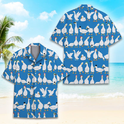 Matching family hawaiian shirt with cartoon ducks on blue background, flat lay