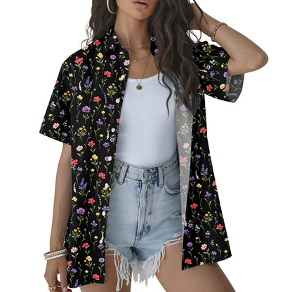 Lifestyle view of a person wearing the black floral hawaiian shirt outdoors