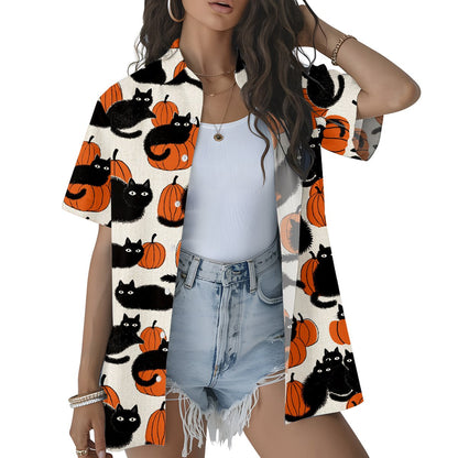 Lifestyle view of matching family hawaiian shirts with Halloween cats and pumpkins.