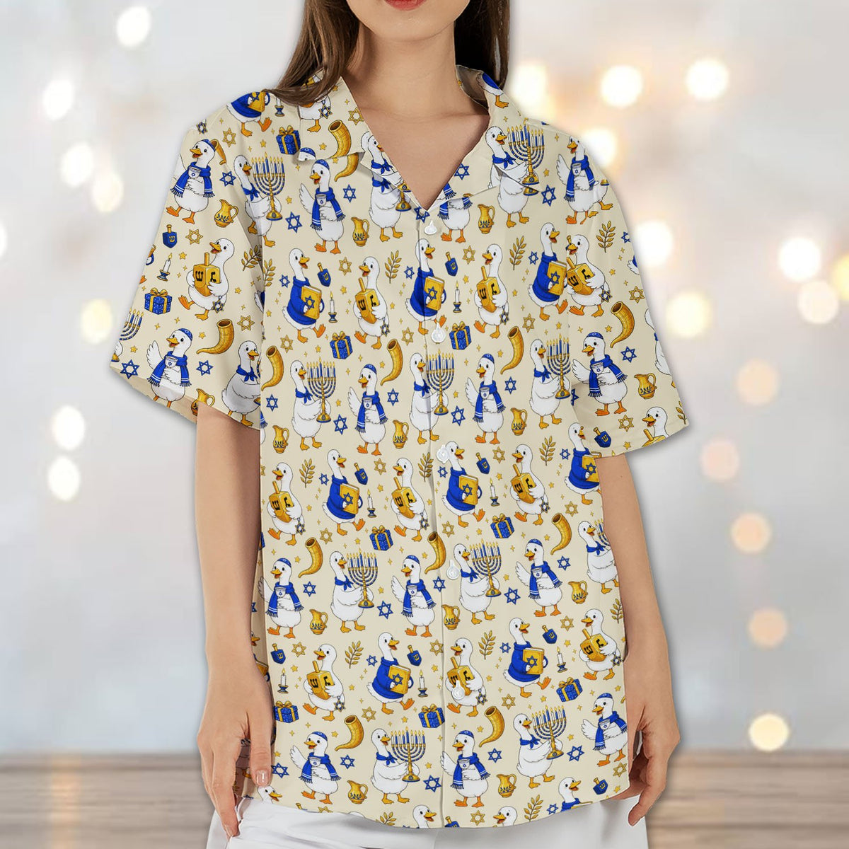 Lifestyle view highlighting the dreidel and menorah pattern on the shirt