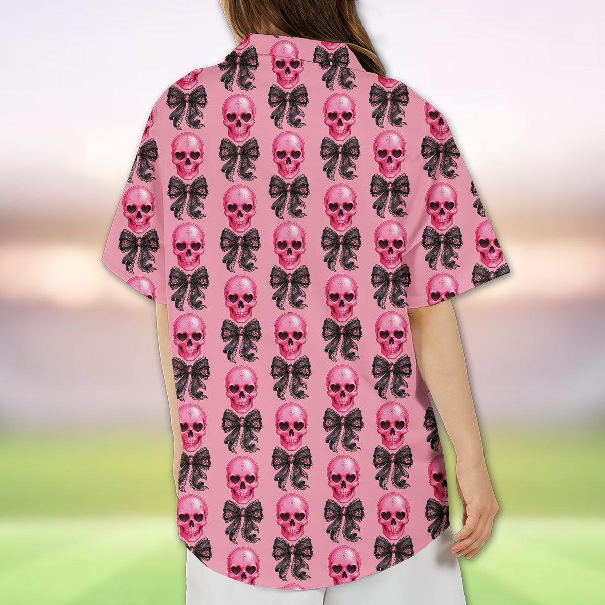 Pink hawaiian shirt skulls pattern with black bows, back view