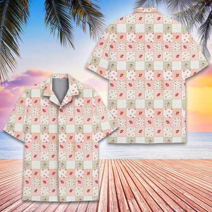 Detail view of the pink, white, and light green strawberry pattern on the hawaiian shirt