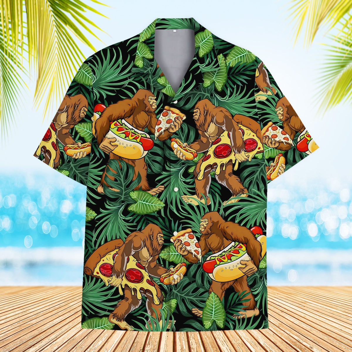 Front view of the black hawaiian shirt with green leaves and Bigfoot holding pizza and hotdogs