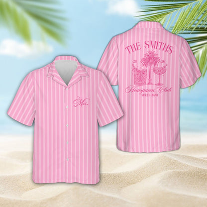 Two people wearing matching pastel tropical honeymoon hawaiian shirts