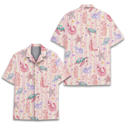 Lifestyle shot of a family wearing matching ocean life hawaiian shirts outdoors