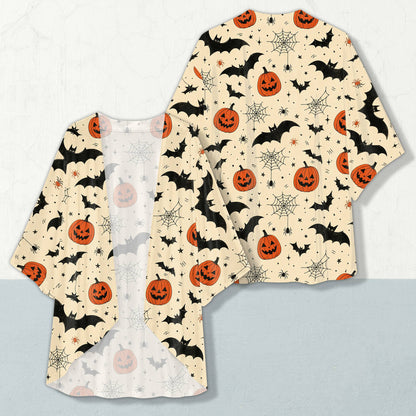 Halloween cardigan featuring black bats and orange pumpkins on a light beige background, front view