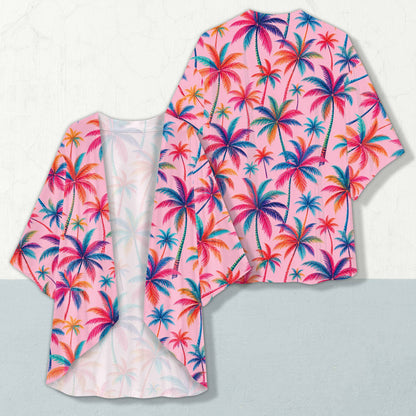 Tropical print cropped cardigan like garment featuring vibrant palm trees on a pink background, front view