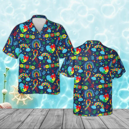 Navy blue autism awareness pajama set with puzzle piece hearts and rainbows, front view