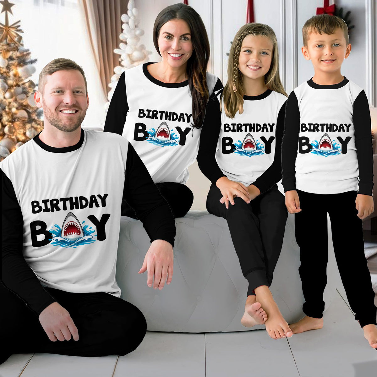 Lifestyle view of a family wearing the matching birthday boy shark pajama set