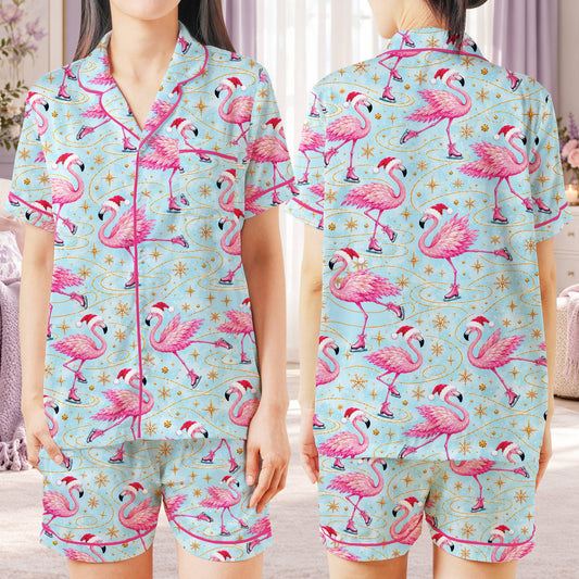 Matching family pajamas with pink flamingos and gold snowflakes on a light blue background, front view