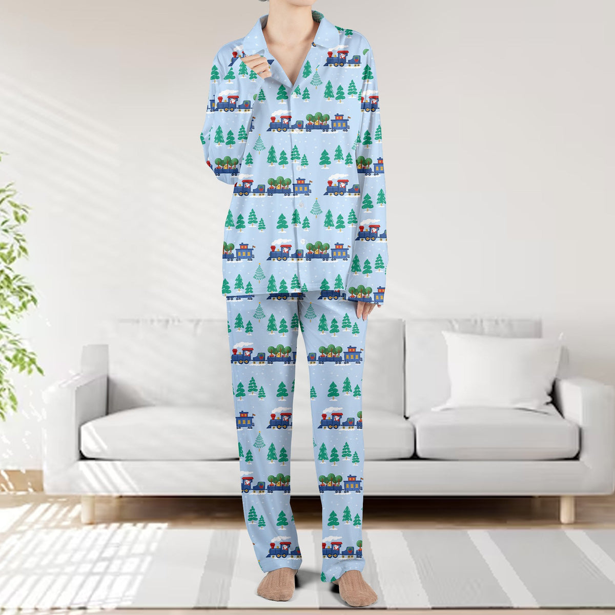 Front view of the light blue christmas pajama set with train and pine tree pattern