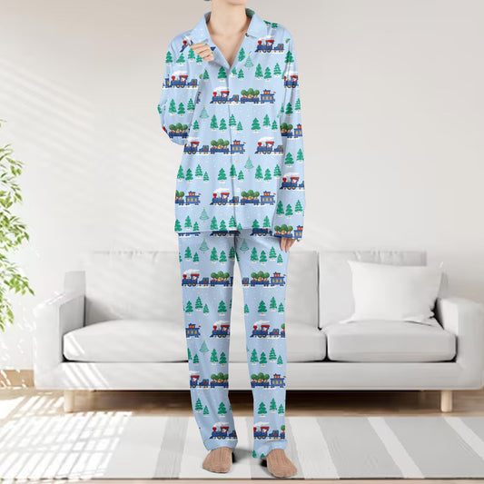 Main matching family christmas pajama set featuring blue toy trains on light blue, front view