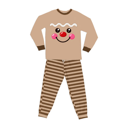 Gingerbread face design on brown top with brown and beige striped pants, front view