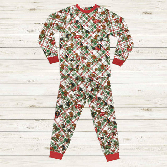 Matching family plaid pajamas featuring festive Christmas dachshunds, front view