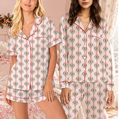 Front view of the pink christmas pajama set top with mistletoe and red stripes