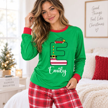 Lifestyle view of the custom christmas pajama set featuring red plaid pants and green elf top