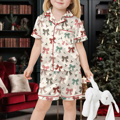 Close up front view of holiday matching family pajamas with pine sprigs and stars
