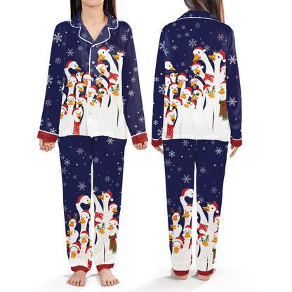 Navy christmas pajama set featuring white ducks in festive accessories with snowflakes