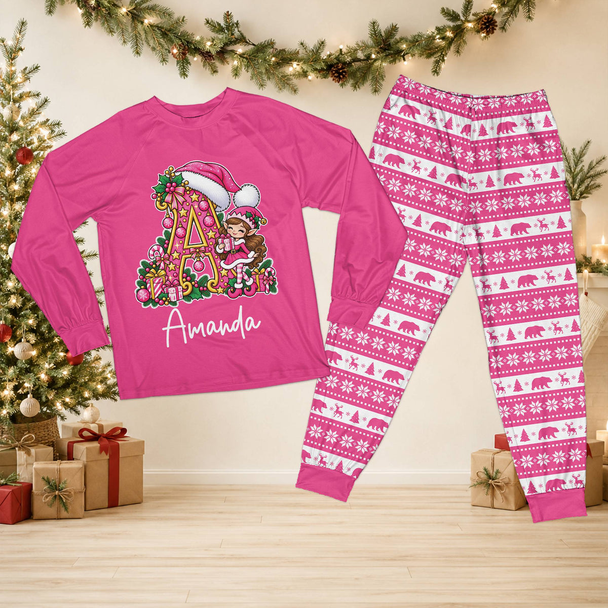 Personalized pink christmas pajama set featuring an elf and Santa hat initial design with custom name, front view