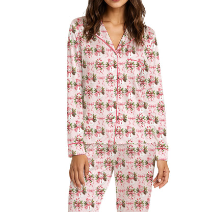 Detailed front view of the pink snowman and bow pajama top and bottoms