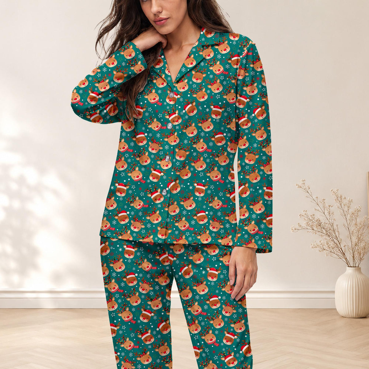 Front view of the matching family pajama set featuring a teal background and reindeer pattern