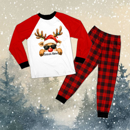 Family matching plaid pajamas with custom name and reindeer design on a white and red raglan top and plaid pants