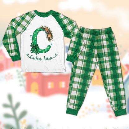 Personalized christmas pajama set featuring a monogram C and custom name on a white top with red and green plaid pants