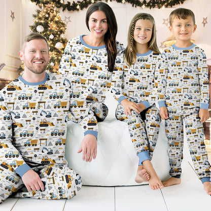 Another lifestyle view of family in matching pajamas with construction design
