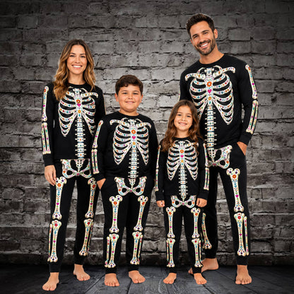 Lifestyle view of a family wearing the matching christmas pajamas for the whole family alternative floral skeleton sets