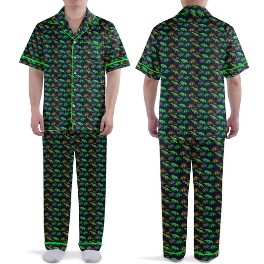 Front view of the dinosaur pajama set featuring colorful neon skeletons on a dark background with green piping