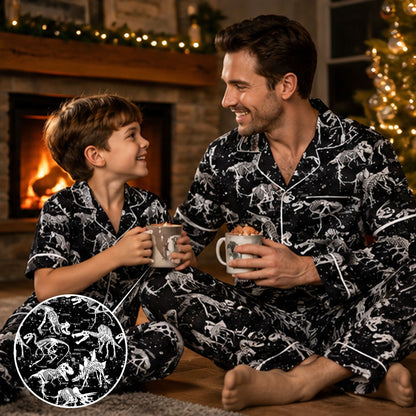 Person wearing matching family pajamas featuring white dinosaur skeletons