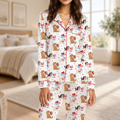 White dogs and hearts pajama set on baby, front view