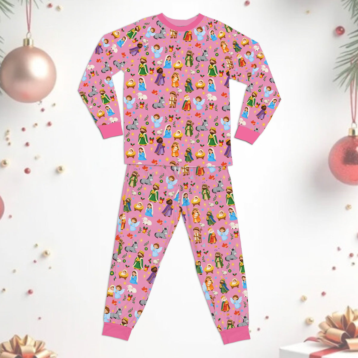 Lifestyle view of individuals wearing the pink nativity scene family pajamas