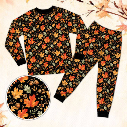 Fall pajama set with autumn leaves on black background, front view