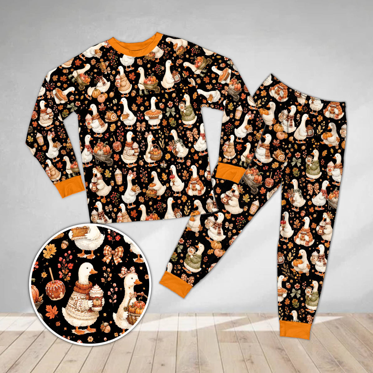 Fall goose pajama set in black featuring illustrated autumn geese, front view