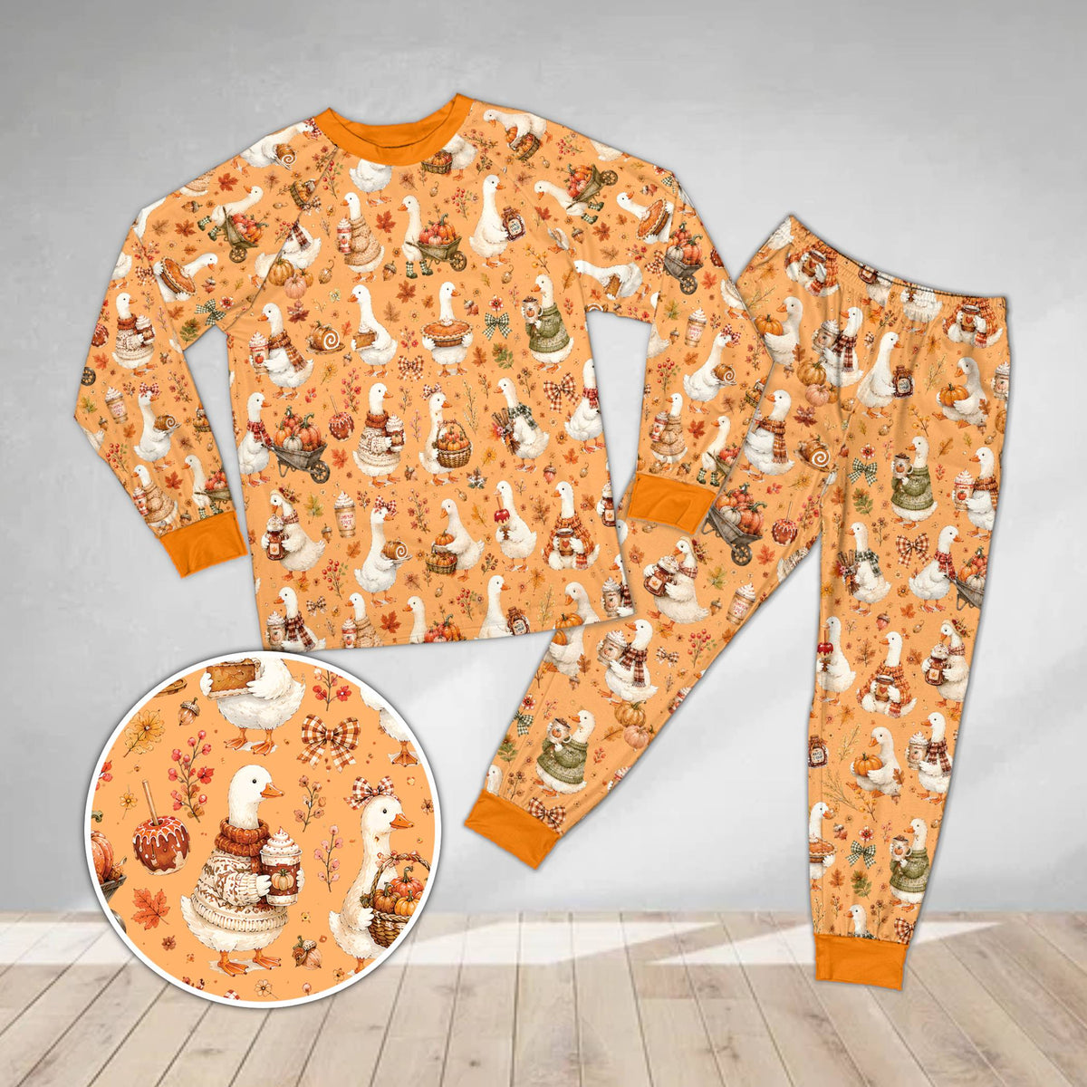 Fall goose pajama set in orange featuring illustrated autumn geese, front view