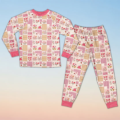 Fall pajama set featuring an autumn patchwork pattern of pumpkins and plaid, alternate front view