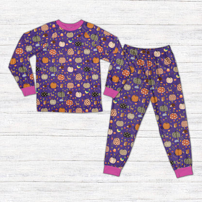 Front view of the family holiday matching pajamas in autumn pumpkin print.