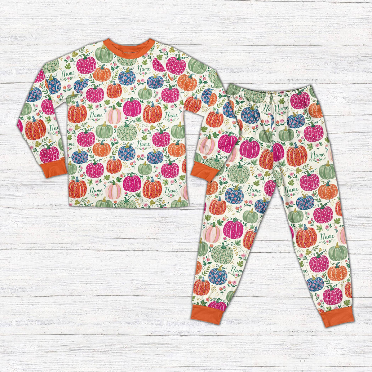 Matching family fall pajama set featuring customized floral pumpkins on a white background